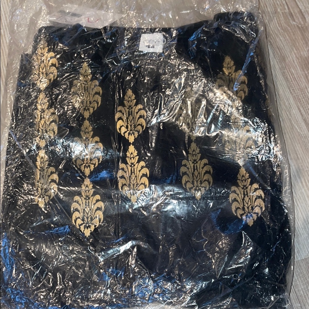 Elegant Black and Gold Patterned Top with Black Pants